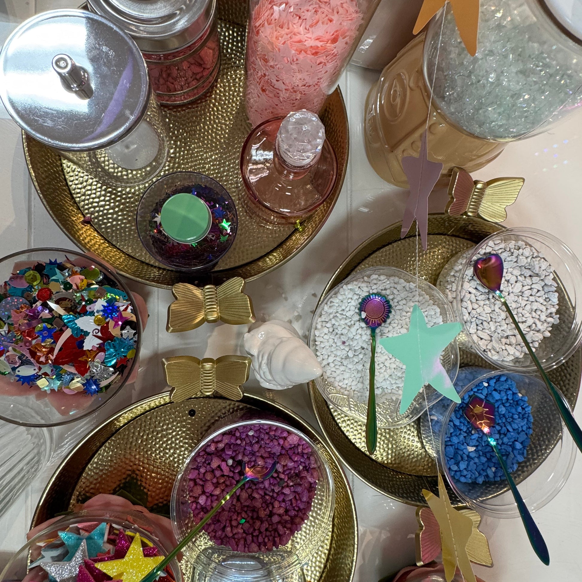 Decorative items including star-shaped objects and colorful confetti on a white surface.