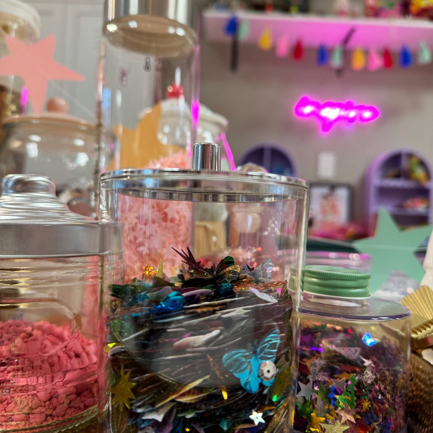Decorative jars with colorful contents on a table in a vibrant setting